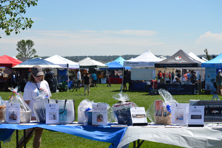A silent auction table was set up near the entrance of the "RexRun" event at Dove Valley Regional Park on Aug. 6, 2022.
